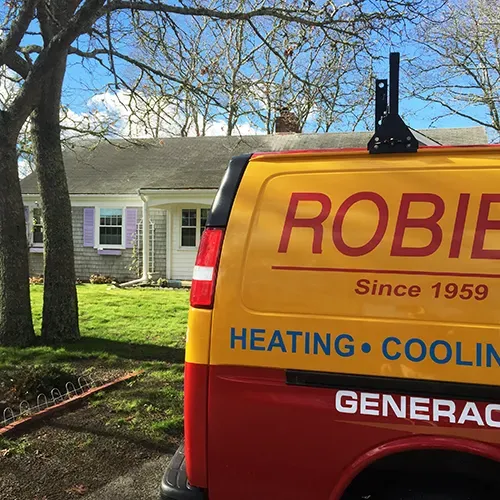 A Robies service van arrives at a Cape Cod home offering heating, cooling, and Generac generator services to both year round residents and seasonal homeowners since 1959.