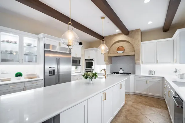 updated remodeled kitchen with white cabinets and white countertops