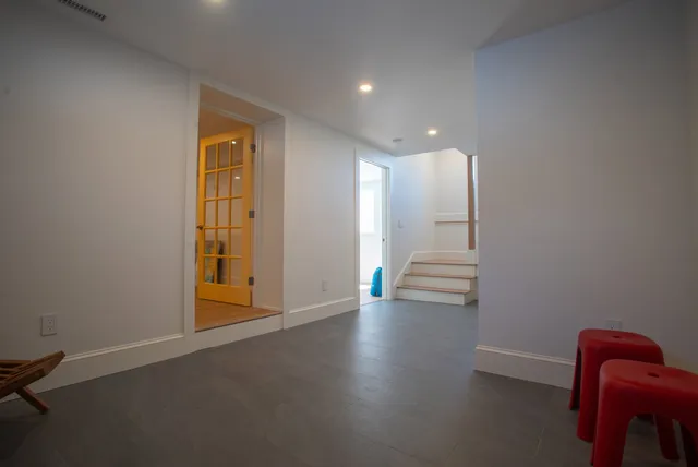 Finished lower level with tile floor and stair access