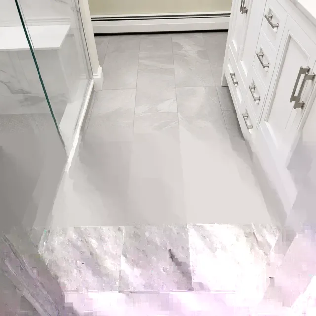 Restored shower tile and grout joints after repair work