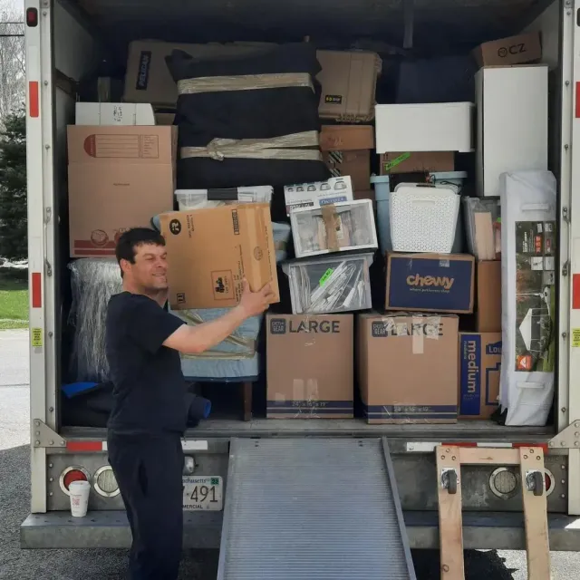 A man is standing in front of a large chewy box