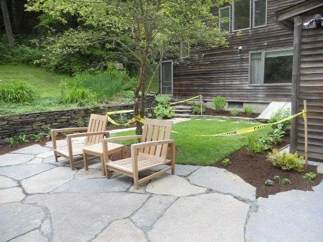 Stone wall, ‘live edge’ patio, steps, garden and lawn