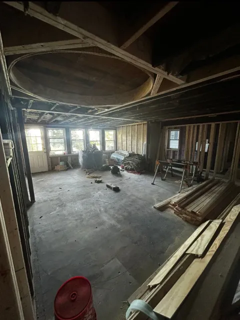 A large room with a lot of wood in it is being remodeled.