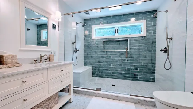 Bright modern bathroom in Rocky Hill, CT with double vanity, walk-in shower, blue tile accent wall, and freestanding tub.