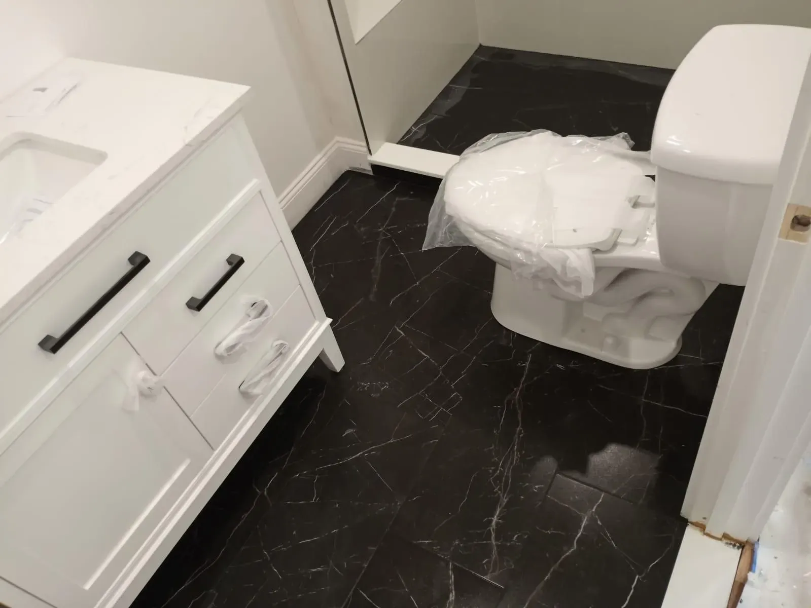 A bathroom with a toilet and a sink in it