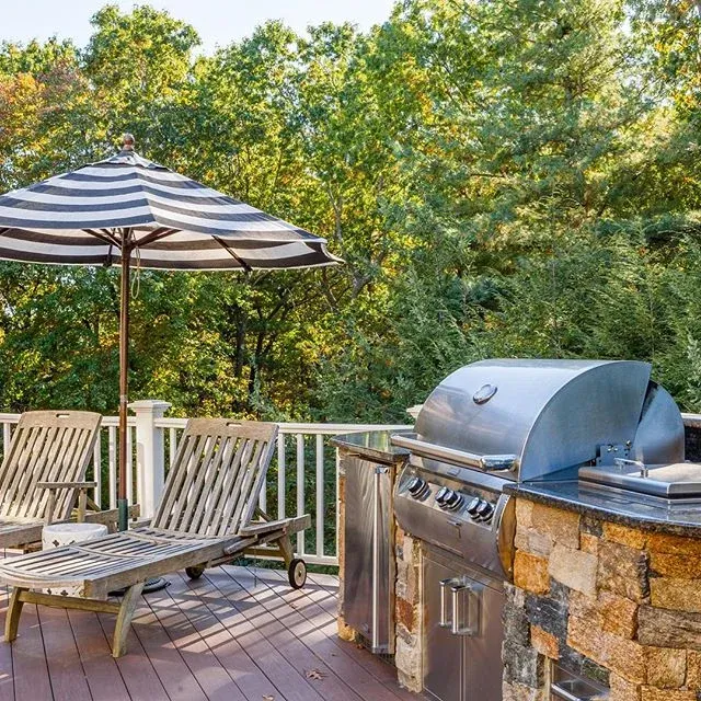 We built this outdoor kitchen for one of our favorite clients &mdash; that grill works hard and there&rsquo;s almost always a lovely bottle of gin chilling in the ice tub.  #outdoorkitchen #designandbuild #newengland #builtingrill #medfield #ginandto