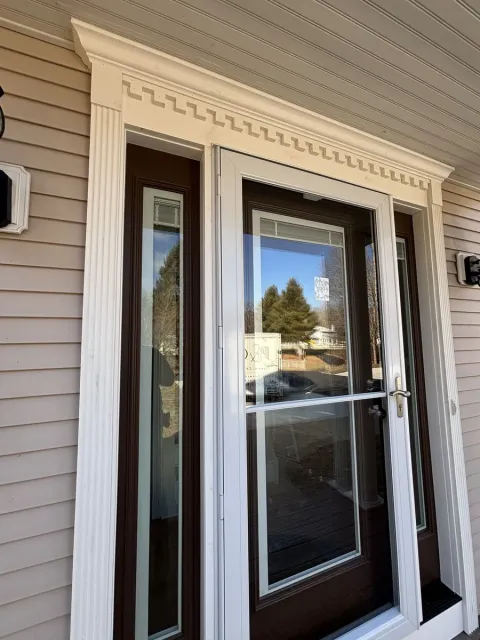 Front entry door with decorative trim and sidelights at a Central Connecticut home by Riverbend Renovations
