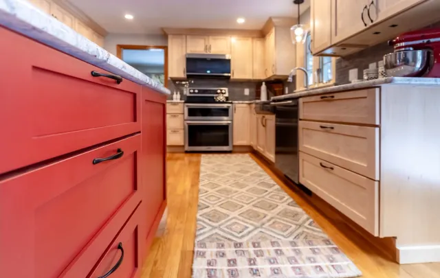 Red Delicious Statement Island with Candlelight Cabinetry.