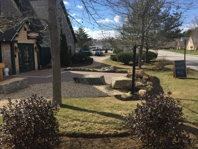 Commercial landscape with crushed stone, hand hewed granite benches. Property management and maintenance