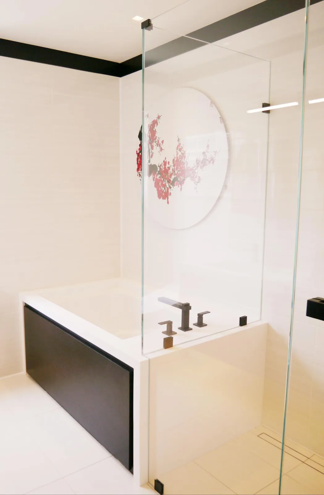 Finished bathroom with soaking tub and glass surround