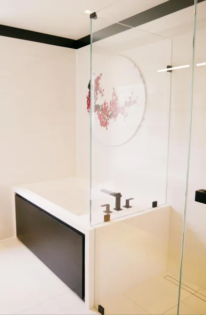 Finished bathroom with soaking tub and glass surround