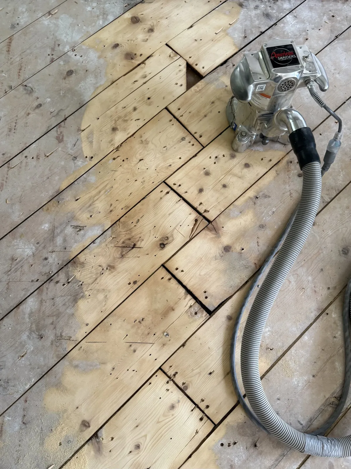 Antique floor mid-restoration with sander