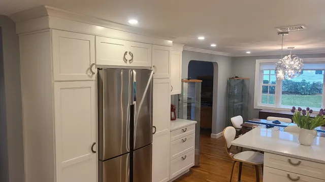 Finished kitchen with quartz island and glass display cabinet