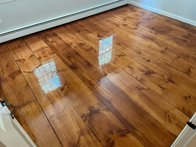 Wide plank hardwood flooring installed in Shrewsbury MA living room.