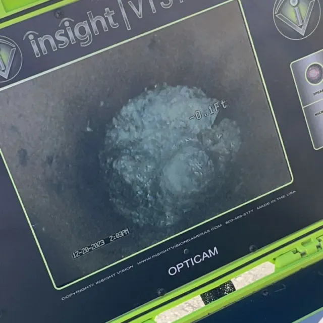 close up on sewer camera inspection monitor showing inside of a clear pipe