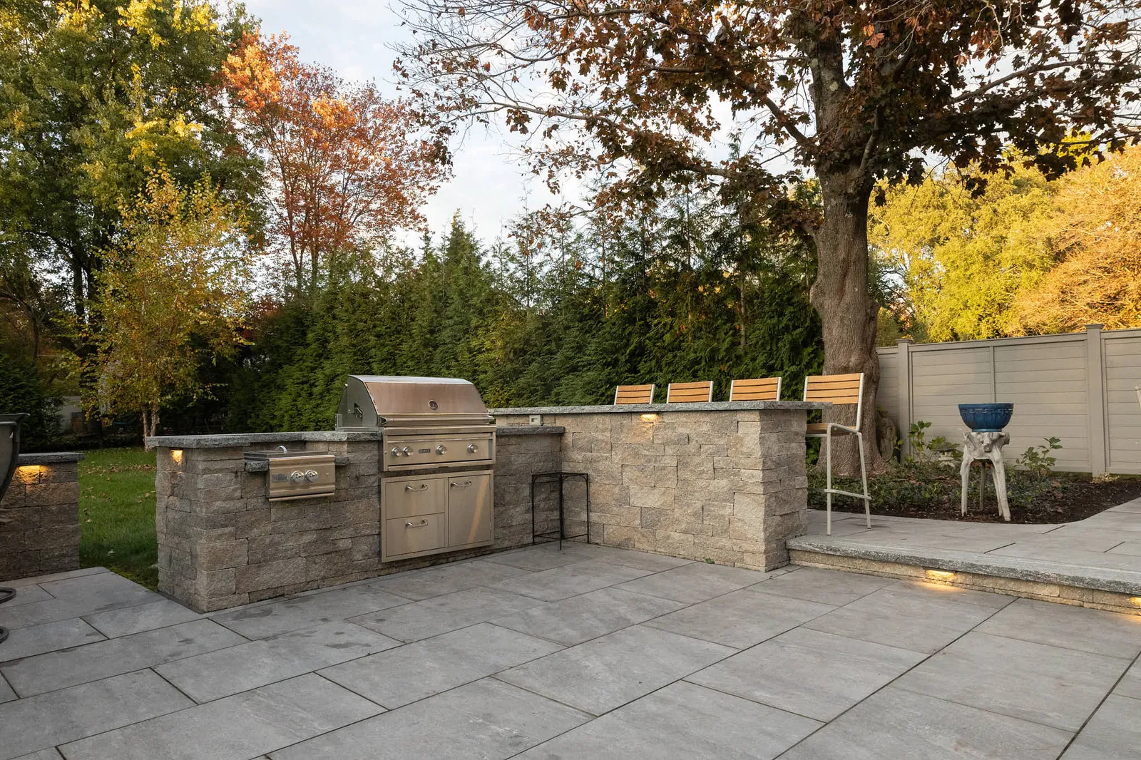 Outdoor Kitchen, porcelain patio and custom lighting installed by JS Hardscapes in Sharon, MA. Low View