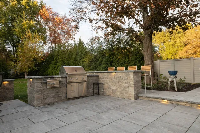 Outdoor Kitchen, porcelain patio and custom lighting installed by JS Hardscapes in Sharon, MA. Low View
