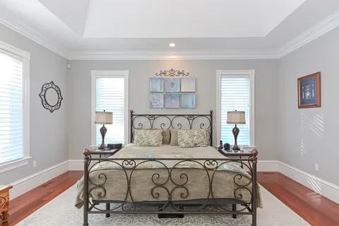 Bedroom with ornate metal bed and two lamps