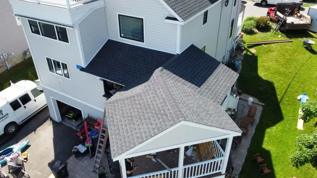 An aerial view of a house with a roof that is being installed.