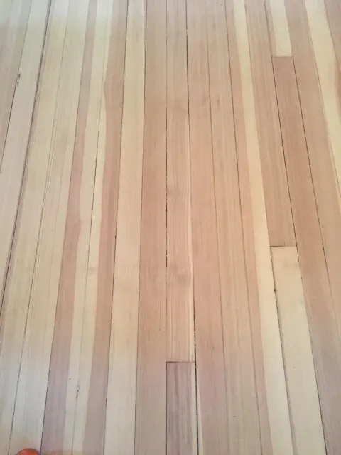Light-colored hardwood floor with vertical grain pattern.