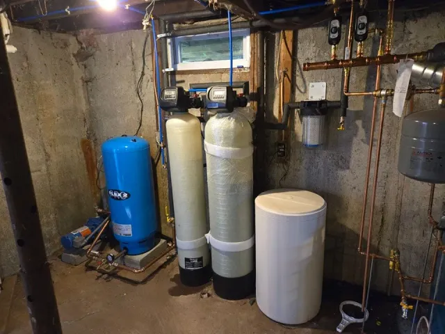 A room with a lot of pipes and tanks in it.