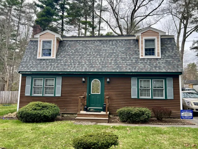 Cape Cod with two dormers, dark wood siding, green front door with arched window, and new CertainTeed Landmark Pro Colonial Slate roof in Lakeville, MA