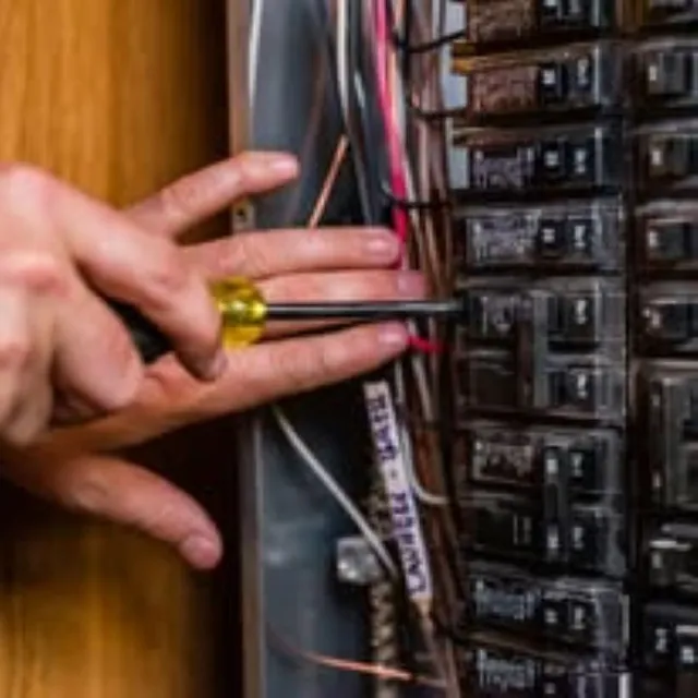 Technician performing residential electrical maintenance and circuit breaker inspection by Preferred Electrical Services, LLC