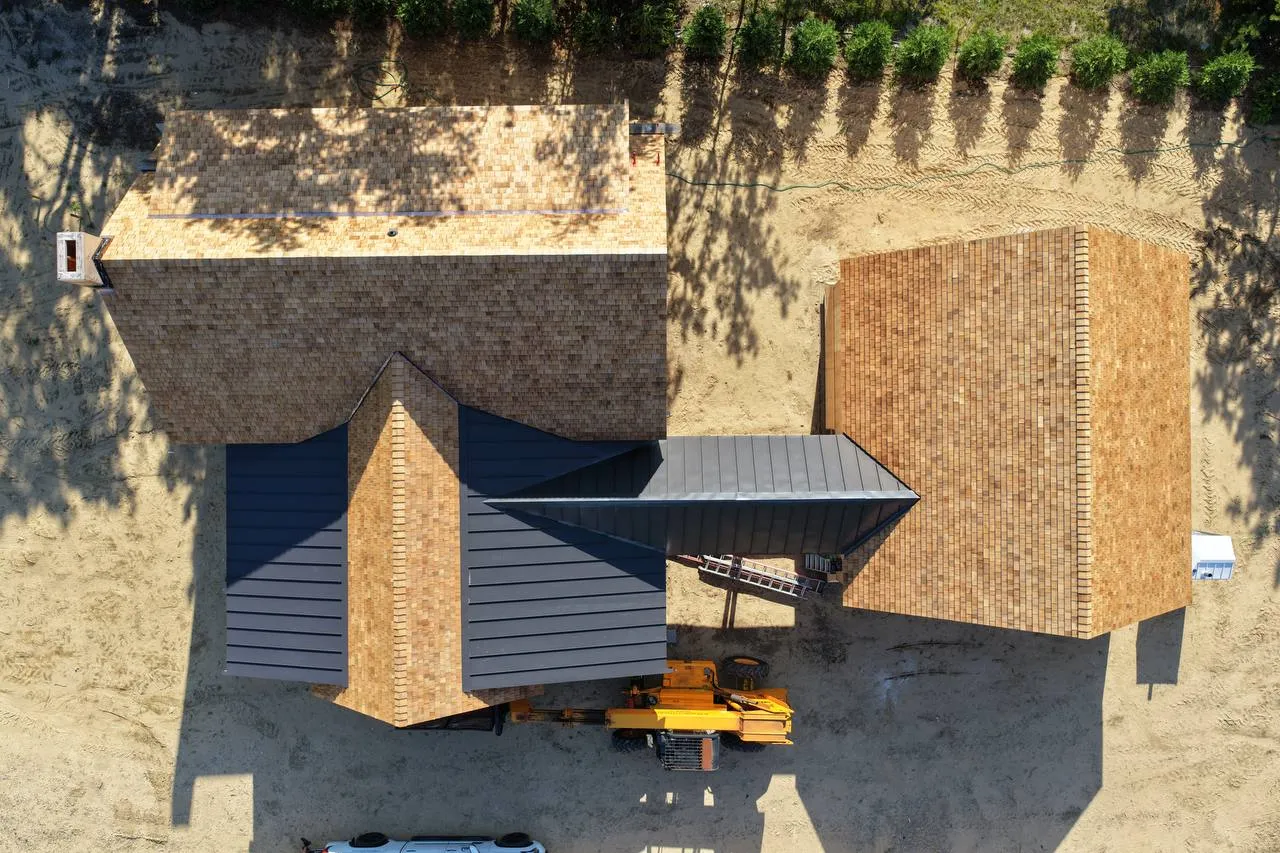 Side elevation showing cedar roof progress and weather-sealed walls