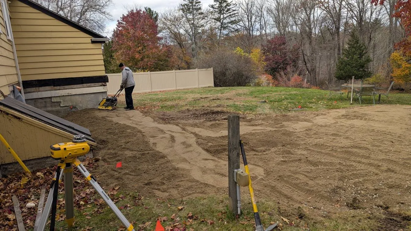 Professional grading and soil compaction work on residential property