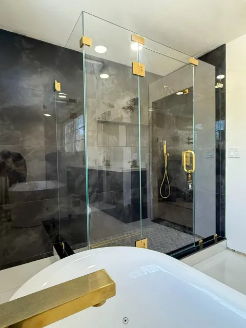 Custom frameless glass shower with gold hardware