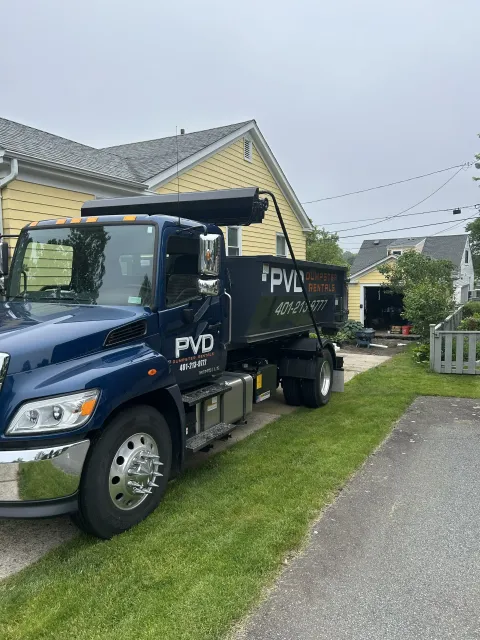 Roll-off dumpster taking cabinets and drywall on a home renovation job in Rhode Island