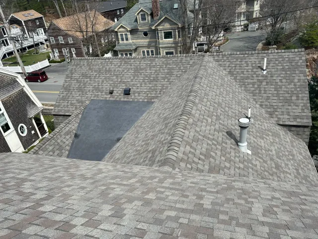 An aerial view of a house 's roof with a chimney on it.