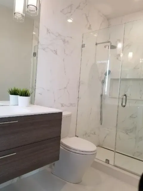 a bathroom with a toilet, sink and shower