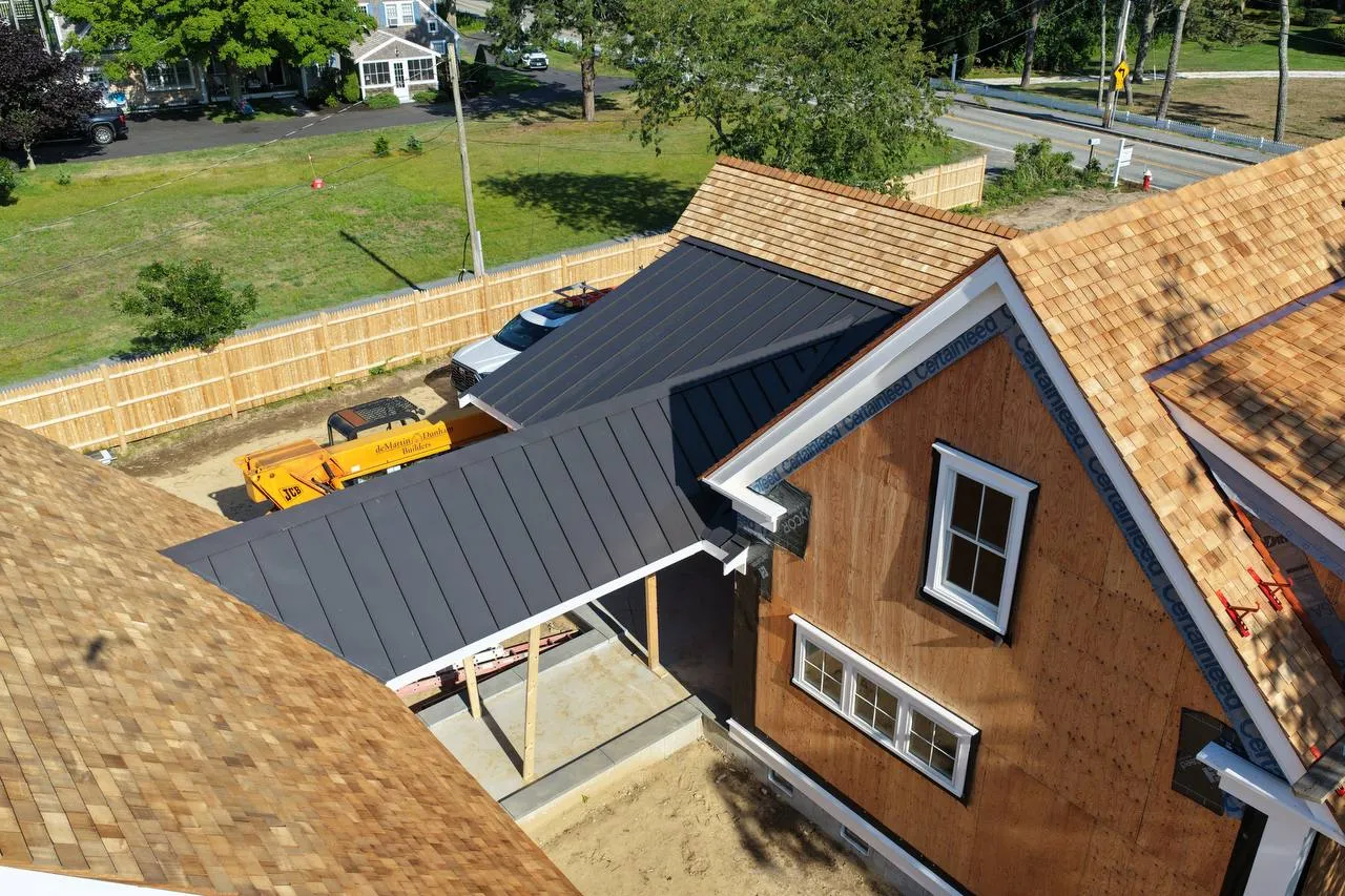 Cedar roof and standing seam metal roof with pond view in background
