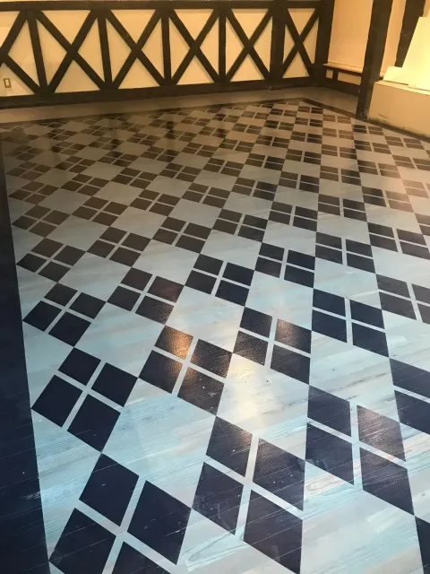 Diamond patterned floor with blue and light gray tiles.