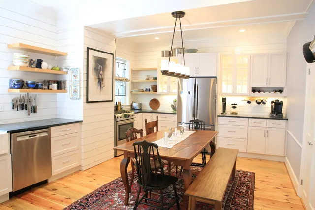 Welcoming kitchen space with shiplap walls and open shelving