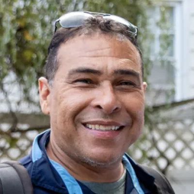John Glen smiling outdoors, owner of Veganix Pest Control