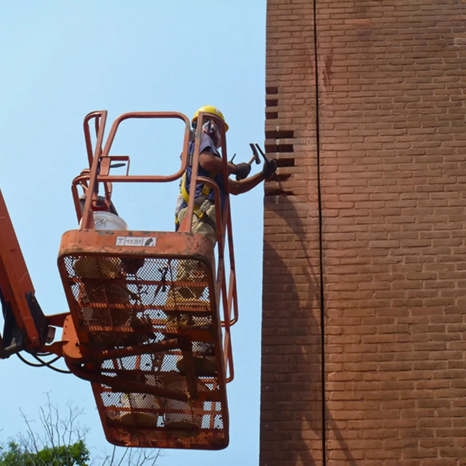 Cenaxo mason performing brick repointing on a historic building facade