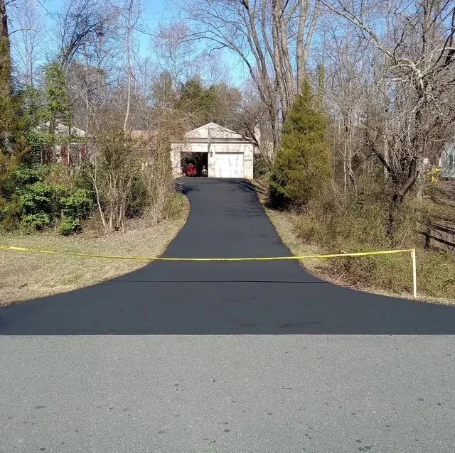 Freshly paved driveway with caution tape