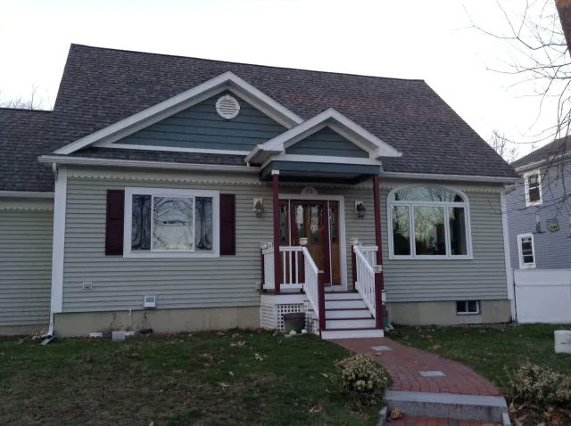 The front of a house with a porch and stairs