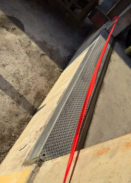 Loading dock overhead door installation with red rope tied to a chain