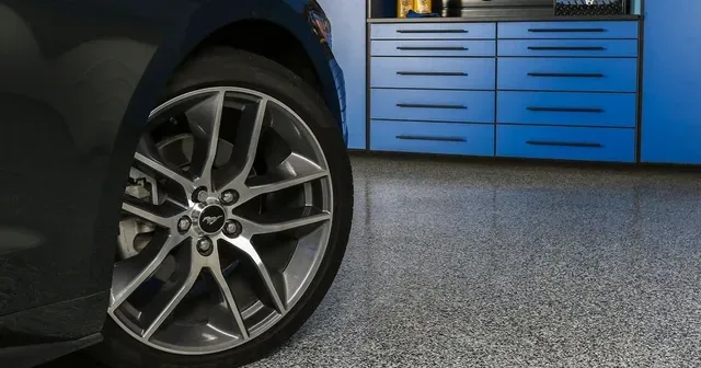 a close up of a car wheel in a garage .