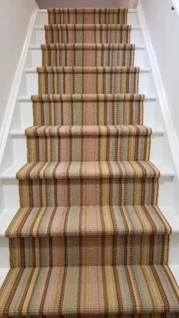 A Dash &amp; Albert woven cotton stair runner installed over synthetic cushion.