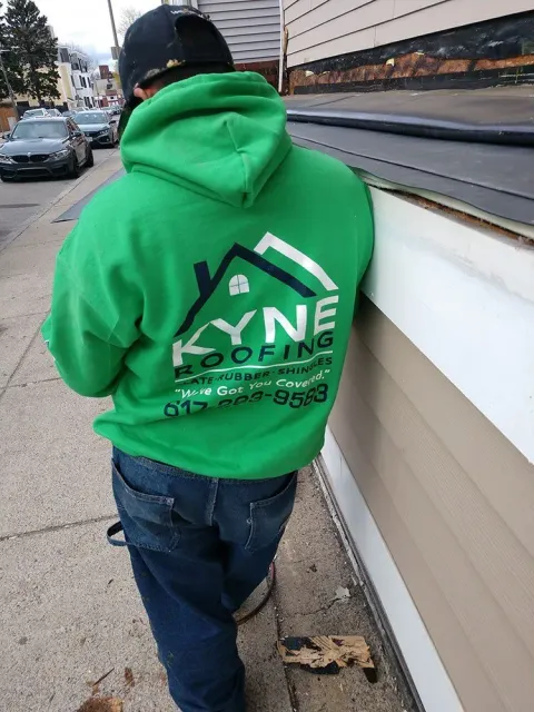 Man wearing a hoody with kyne roofing logo on it