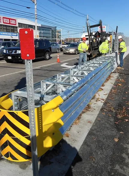 Crew installing roadside guardrail