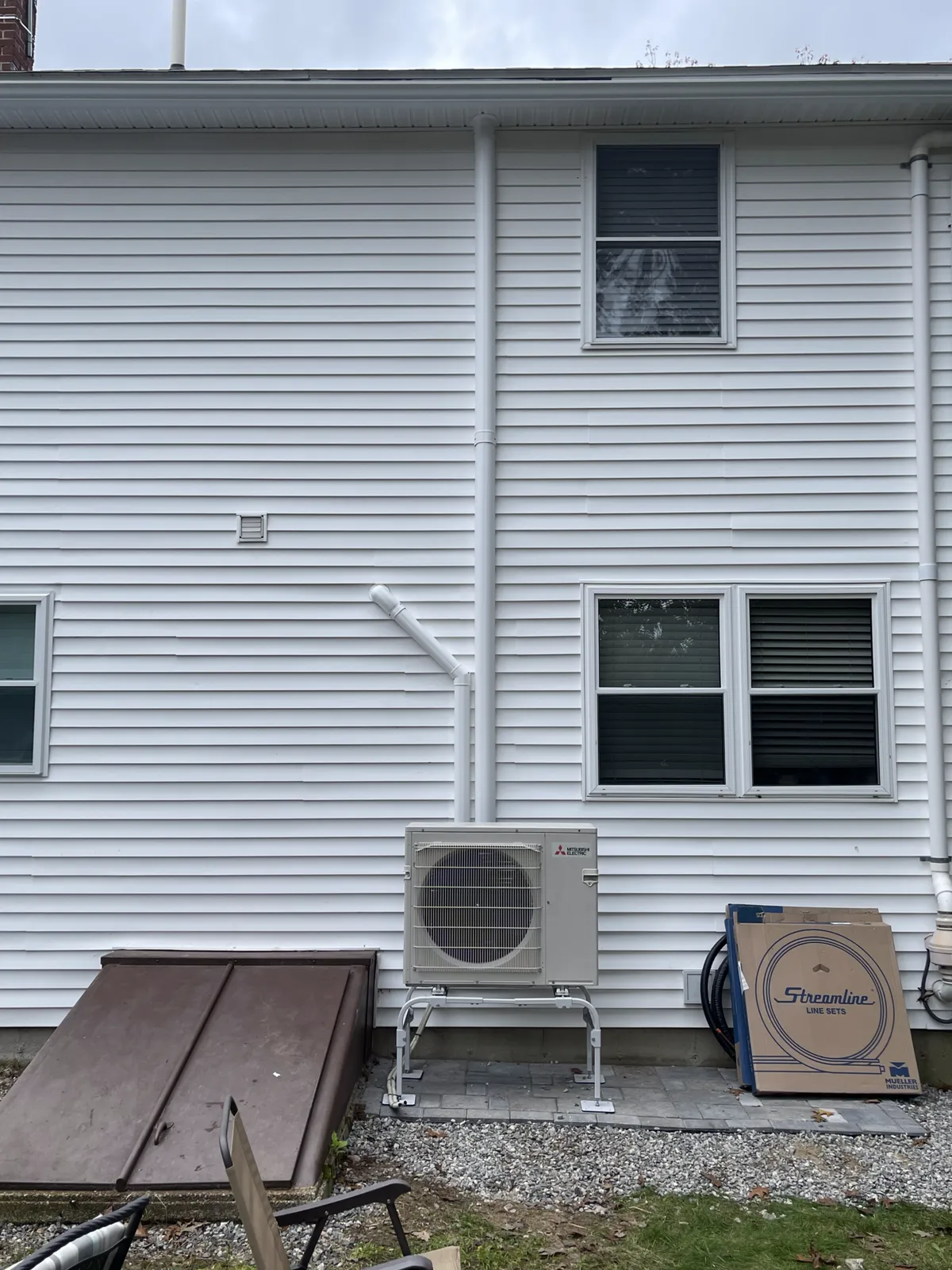 Mitsubishi heat pump installed on a residential exterior