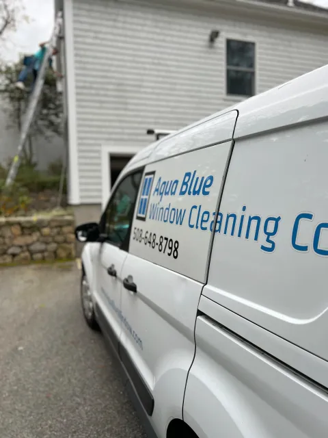 Aqua Blue Window van with worker on ladder