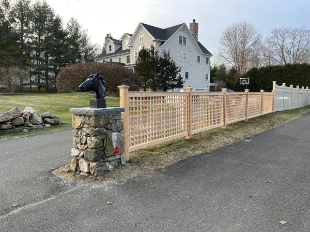 A wooden fence with a horse head on top of it