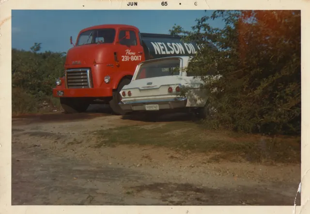 A vintage Nelson Oil delivery truck in a historic photograph