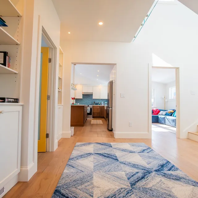 Hall view into the renovated kitchen and living room